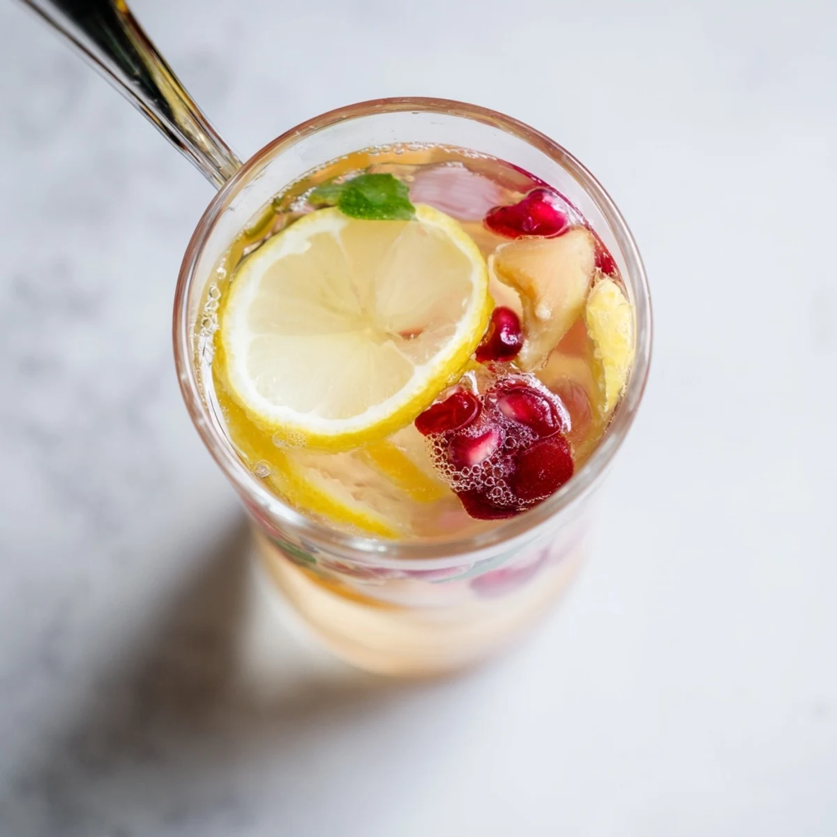 Refreshing homemade Kombucha-style mocktails in glass bottles, infused with fresh berries and mint.  