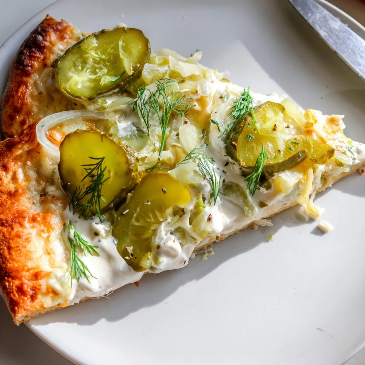 Tangy Pickle Pizza featuring creamy crème fraîche, mozzarella, and crunchy dill toppings.  