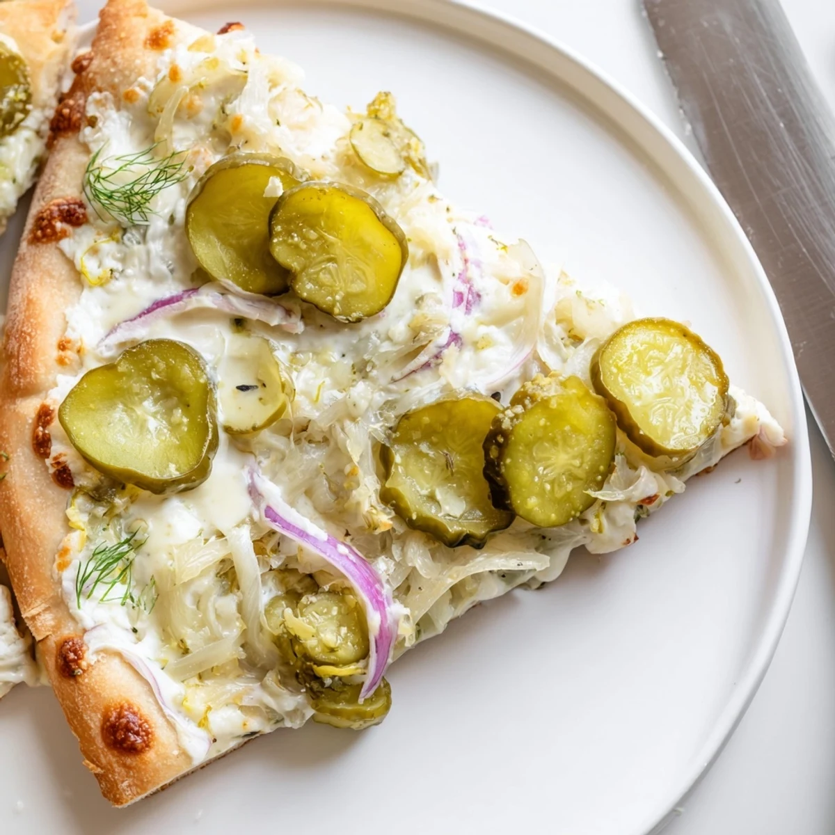 Delicious Pickle Pizza fresh from the oven, garnished with vibrant fresh dill.  