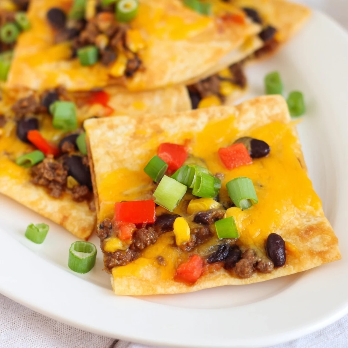 Sheet pan quesadillas with beef are golden and crispy, oozing with melted cheese and savory beef.