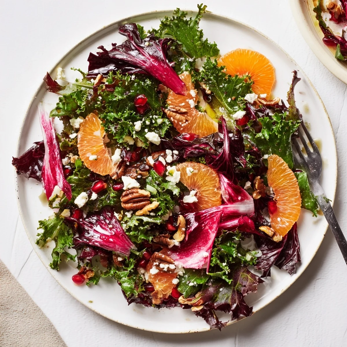 Vibrant Winter Greens Salad with citrus, pomegranate, and toasted nuts, a refreshing and colorful dish.