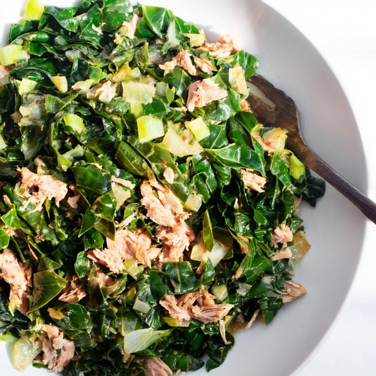 Hearty Southern style collard greens with chunks of smoked turkey, ready for serving with cornbread.