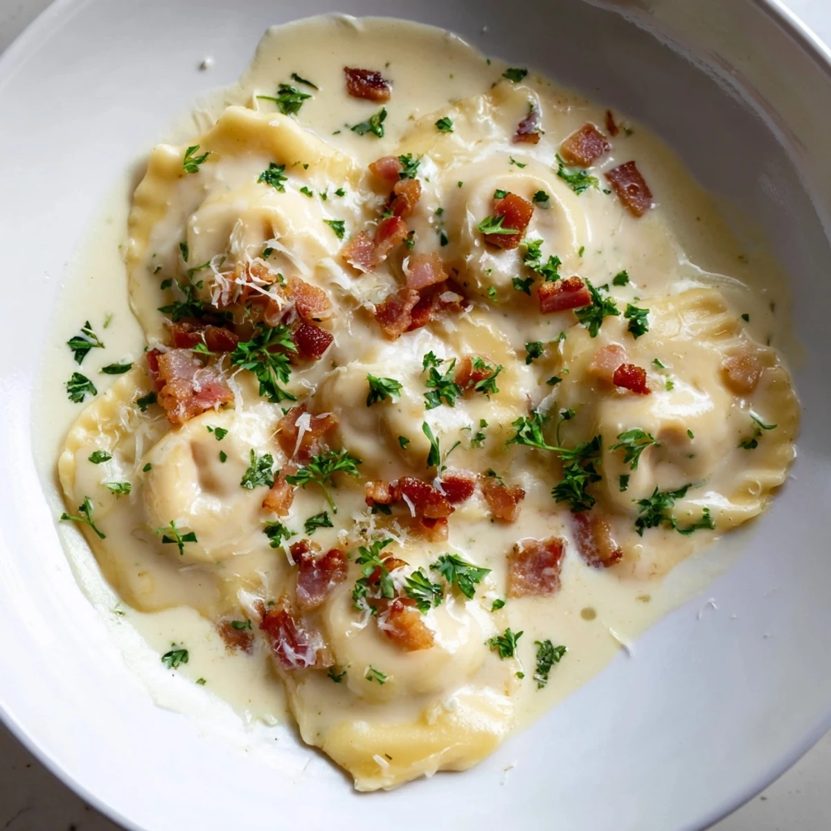 A close-up of delicious Olive Garden Ravioli Carbonara; imagine the flavorful, rich carbonara sauce coating each ravioli.