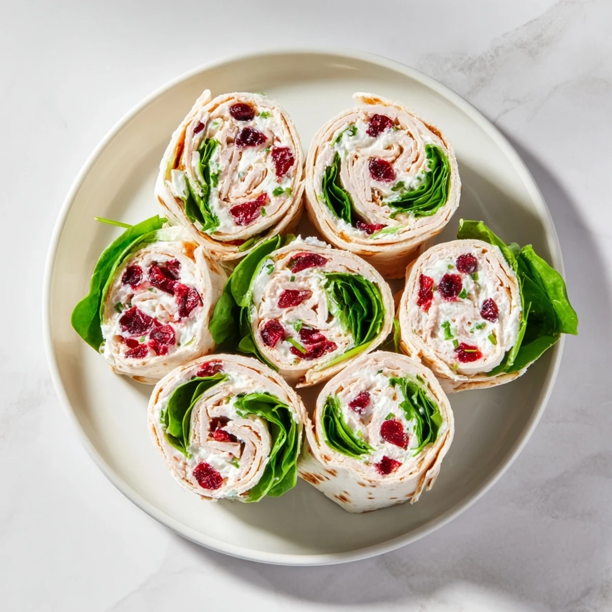 Close-up of freshly sliced turkey cranberry pinwheels, a perfect appetizer for any festive occasion.