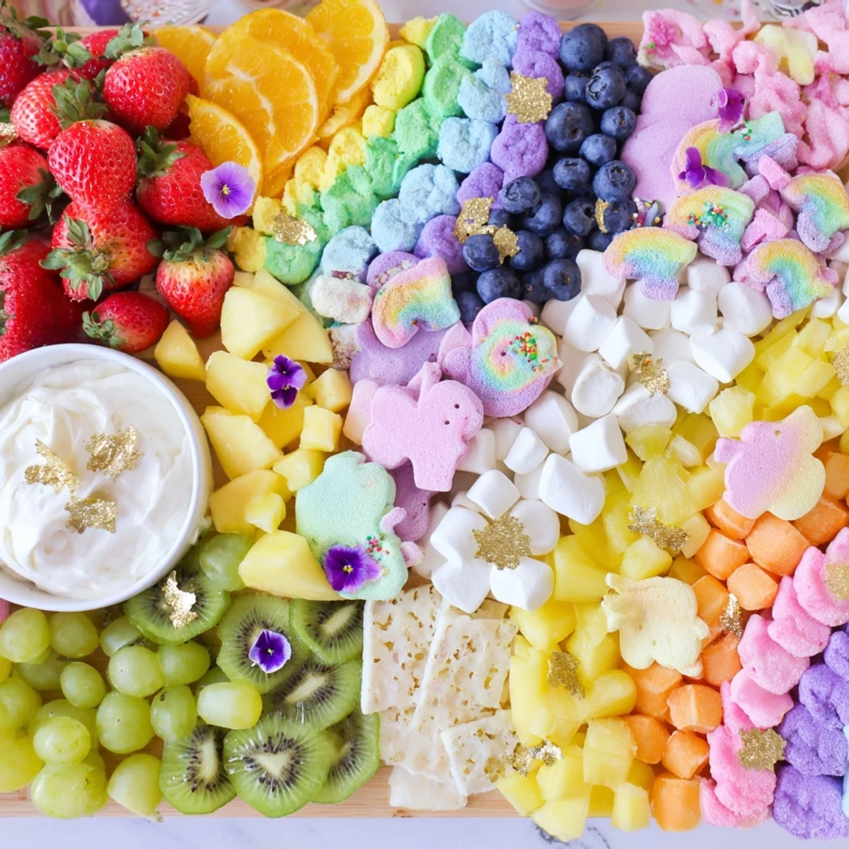 Magical Unicorn Rainbow Dessert Board overflowing with vibrant fruits, sweets, and colorful treats ready for serving.