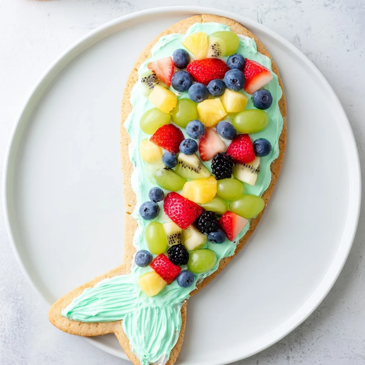 Imagine the fun: A beautiful Under the Sea Mermaid Tail Fruit Pizza ready to be sliced and enjoyed at any party.