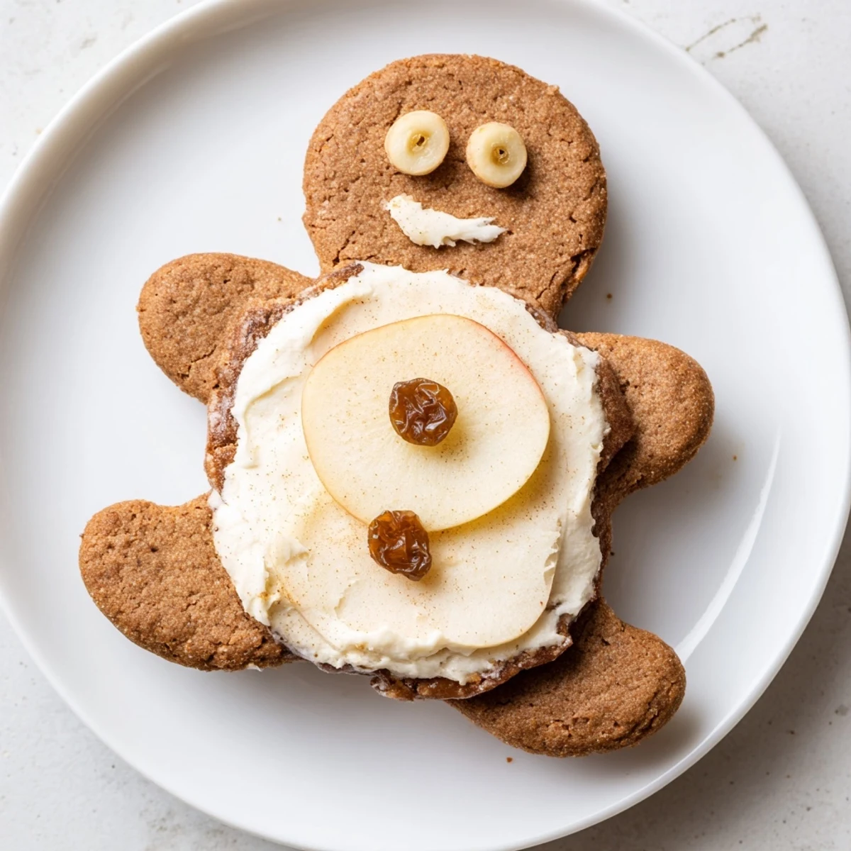 Smiling gingerbread men sandwich cutouts, fruity and creamy, a fun American lunch.