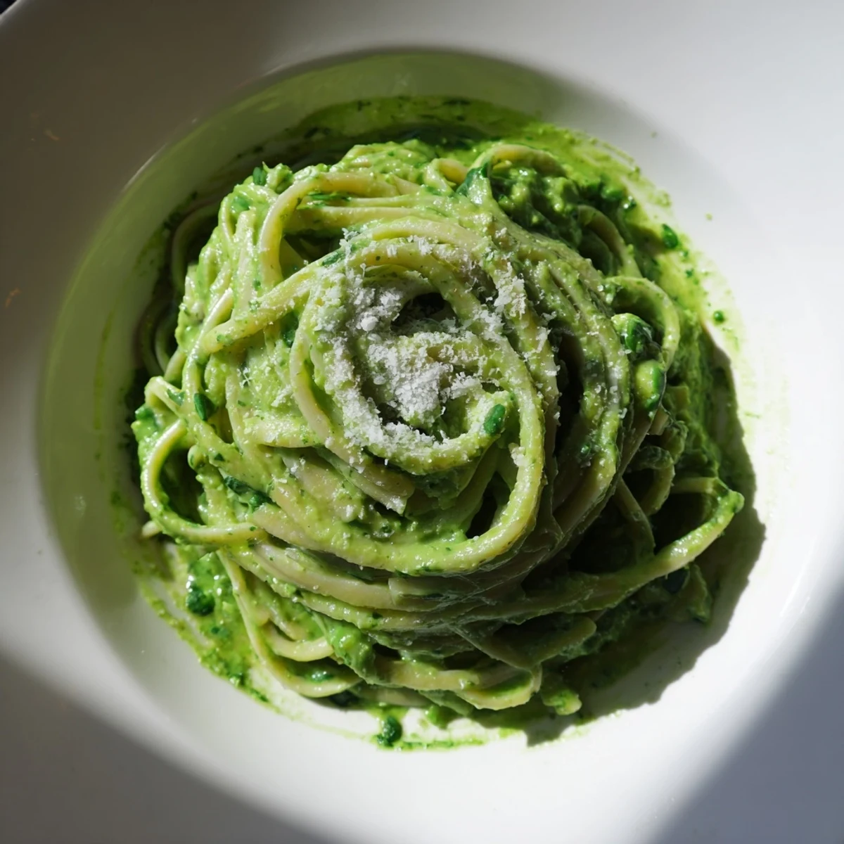 Vibrant bowl of Green Goddess Pasta Sauce, ready to coat pasta with herbaceous flavor and creamy texture.
