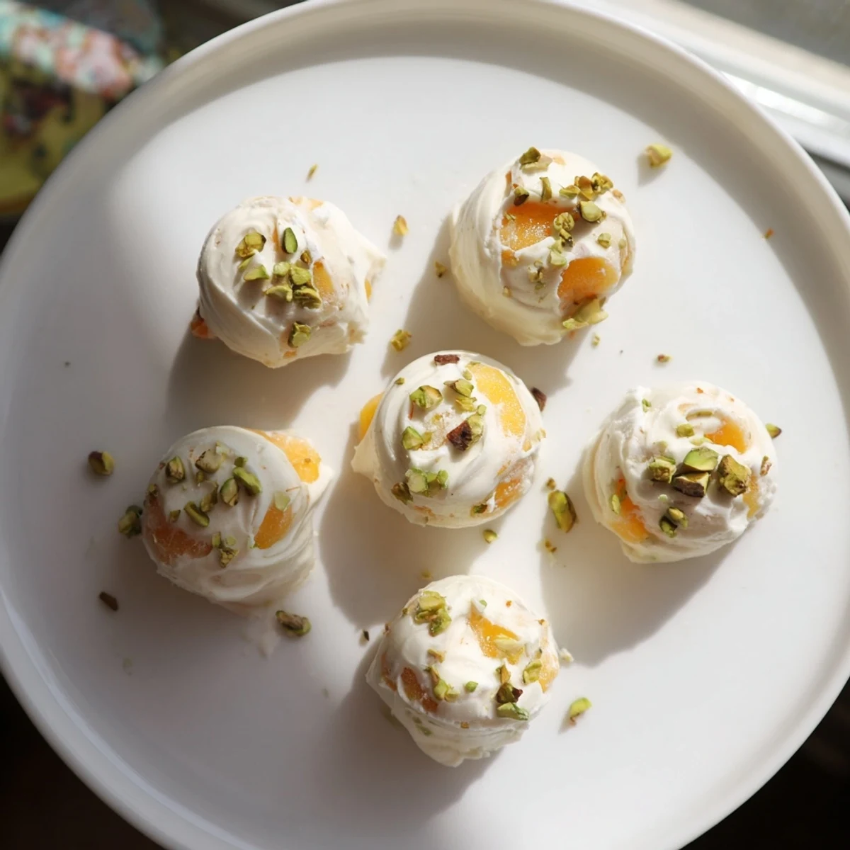 Frozen peach yogurt bites, frozen solid with juicy peach pieces, a cool treat for summer afternoons.