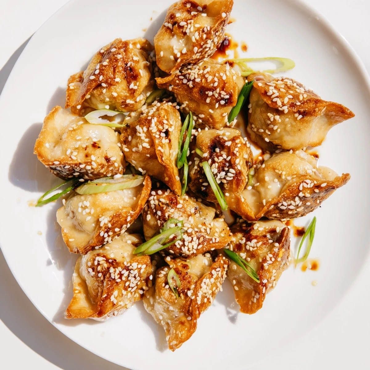 Steaming plate of Air Fryer Frozen Dumplings garnished with green onions and sesame seeds – a delicious snack.