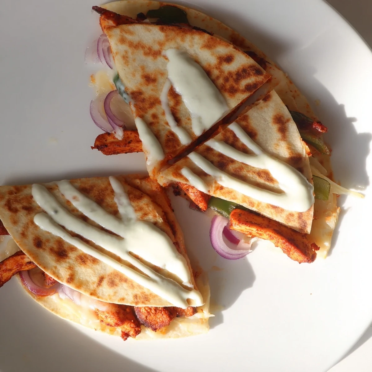 Sizzling Tandoori Chicken Quesadilla featuring melted cheese and a colorful vegetable filling, perfect for dinner.