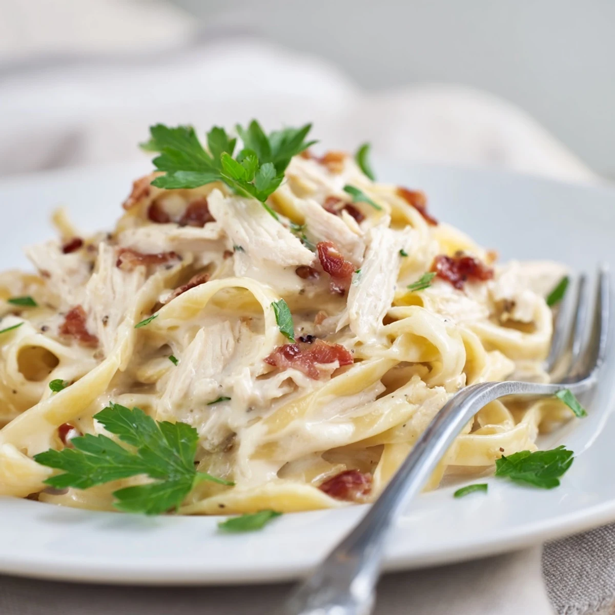 Shredded chicken and spaghetti tossed in a glossy Parmesan-egg sauce for a comforting dinner.