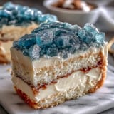 Showstopping vanilla cake featuring a teal and gold geode slice, offering a modern twist on traditional graduation desserts.