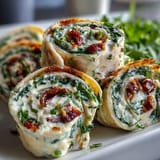 Savory turkey and cheddar pinwheels with fresh spinach, sliced into bite-sized snacks for lunchboxes or appetizers.
