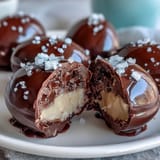 Indulgent peanut butter-filled Easter eggs coated in rich dark chocolate and finished with a sprinkle of sea salt, offering a sweet-salty flavor combination.