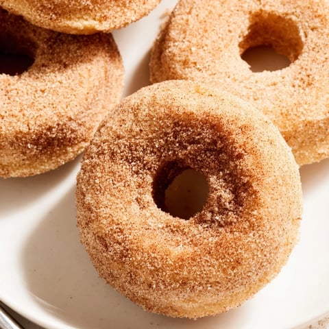 Warm, freshly baked cinnamon-sugar donuts ready to be enjoyed, a classic American treat.