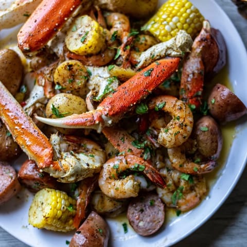Festive seafood boil featuring juicy crab and shrimp, spiced sausage, and corn.  