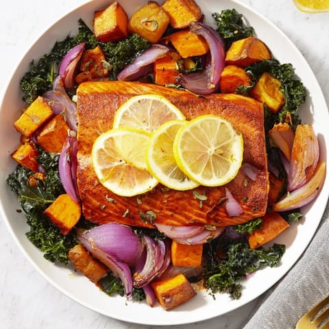 Flaky sheet-pan salmon sits atop tender, caramelized root vegetables in a delightful dish.