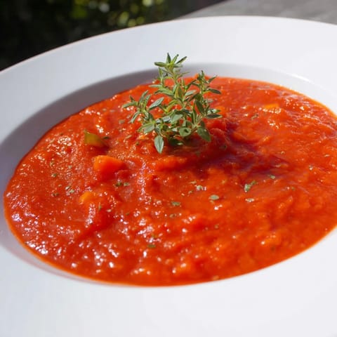 Smooth, blended veggie-loaded tomato pasta sauce with rich red color, ready to spoon over healthy pasta.