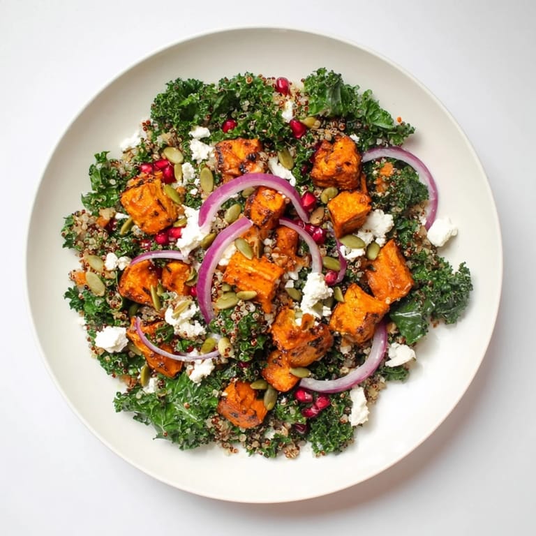 Freshly tossed Kale & Quinoa Salad featuring sweet potato, dressed in zesty lemon, ready to eat.