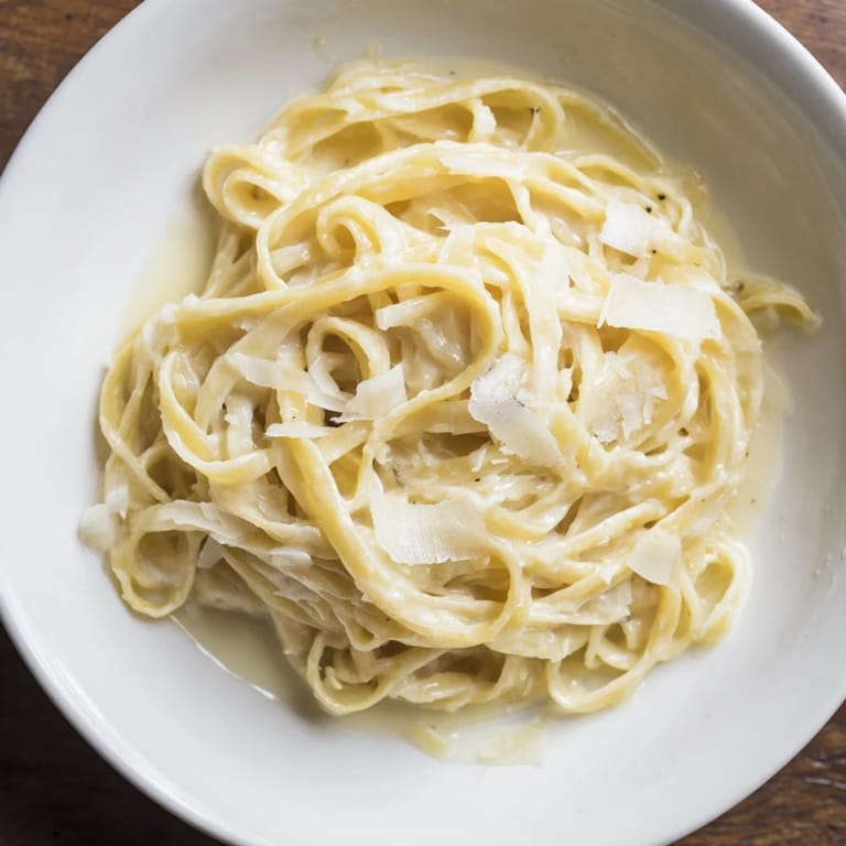 Perfectly cooked Lazy Girl Three-Ingredient Pasta, coated in a velvety sauce, and garnished with fresh pepper.