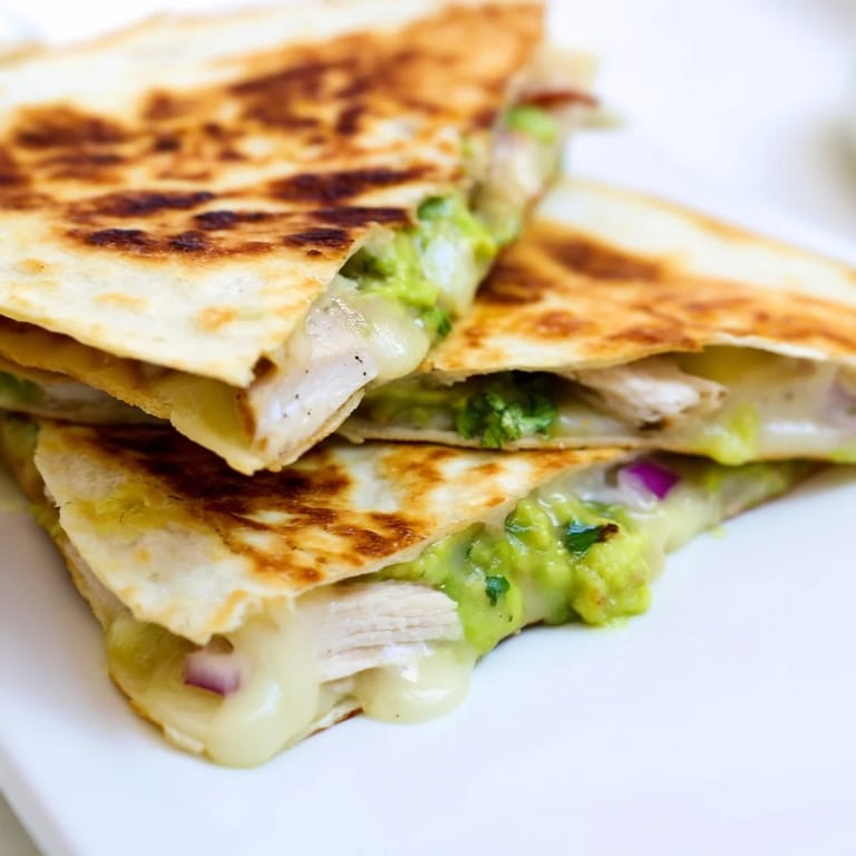 Served warm with lime wedges and a side of salsa, this Chicken Avocado Quesadilla looks deliciously inviting.