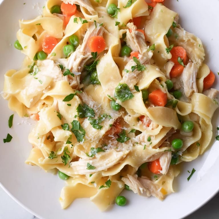 Serve this bright Spring Chicken Noodle Skillet garnished with fresh parsley, a sprinkle of Parmesan, and lemon wedges for a zesty, weeknight-friendly meal.